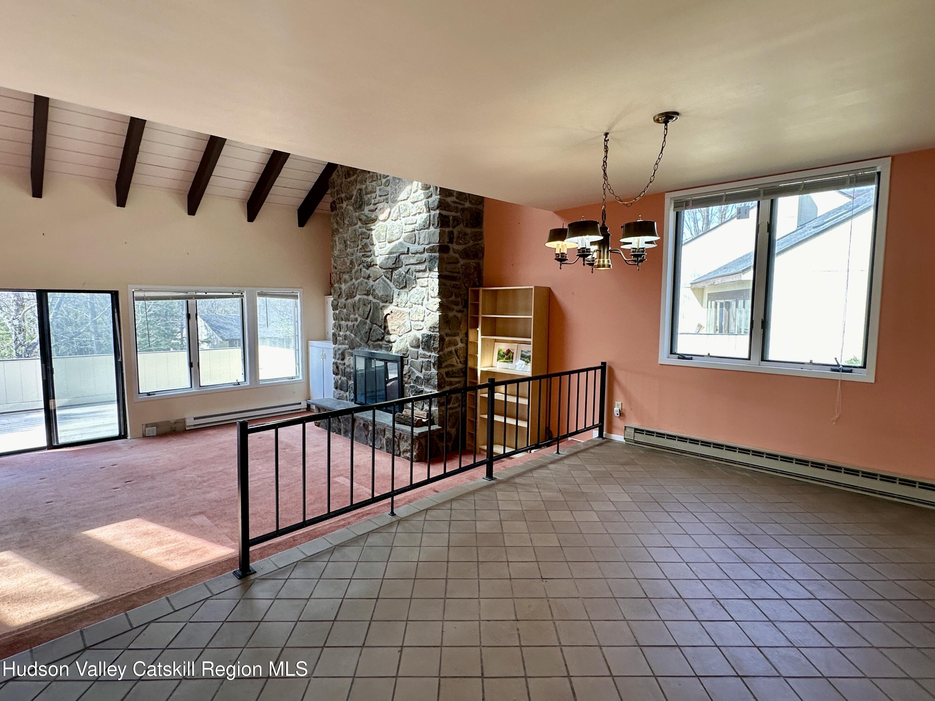 260 Pines Drive, Unit 82 Roxbury, NY 12421 - Photo 10 of 31 an empty room with windows and ceiling fan