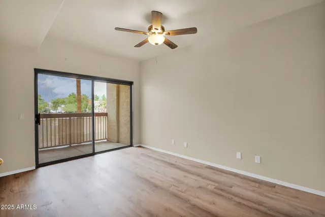 a view of a livingroom with a ceiling fan and window