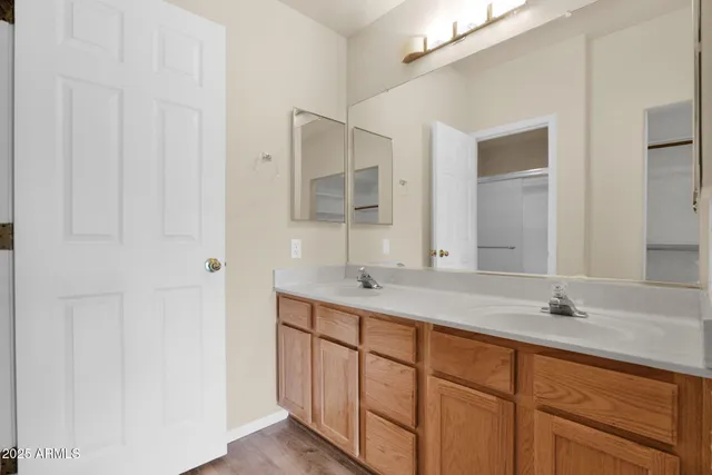 a bathroom with a double vanity sink and mirror