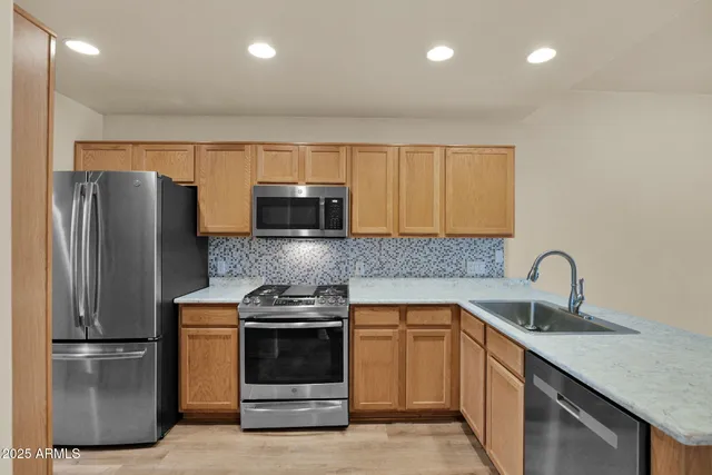 a kitchen with a sink and stainless steel appliances