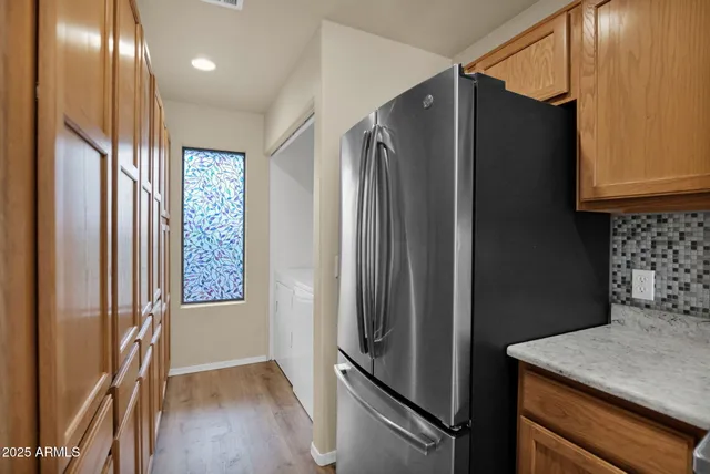a kitchen with stainless steel appliances granite countertop a refrigerator and a sink