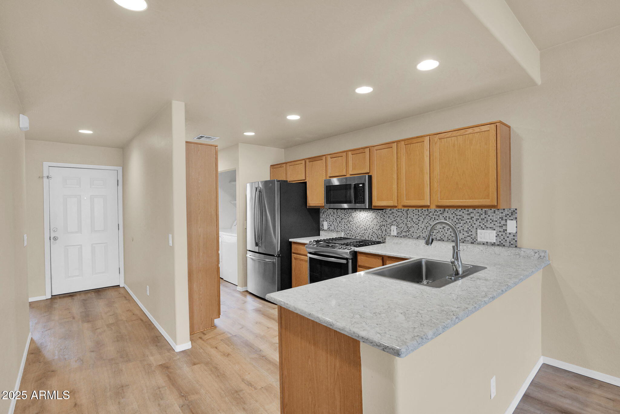 205 North 74th Street, Unit 260 Mesa, AZ 85207 - Photo 7 of 37 a kitchen with stainless steel appliances granite countertop a sink a stove and a refrigerator