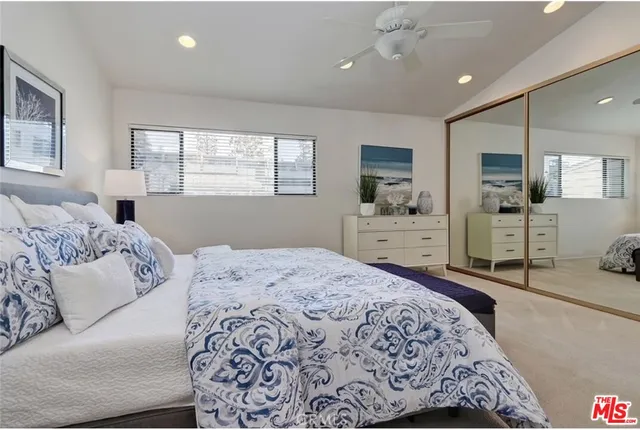 a bedroom with a large bed and a flat screen tv