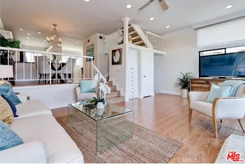 a living room with furniture and kitchen view