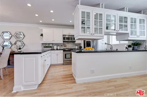 a kitchen with stainless steel appliances granite countertop a stove and cabinets