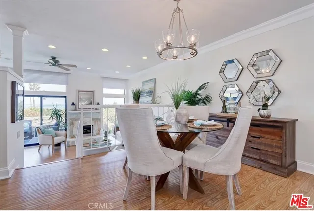 a view of a dining room with furniture wooden floor and chandelier