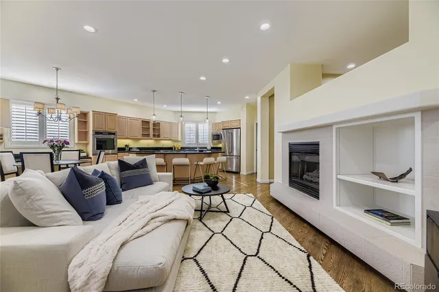 a living room with furniture kitchen and a fireplace