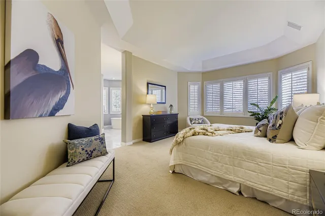 a spacious bedroom with a bed and a couch