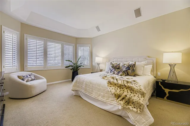 a spacious bathroom with a tub sink and mirror
