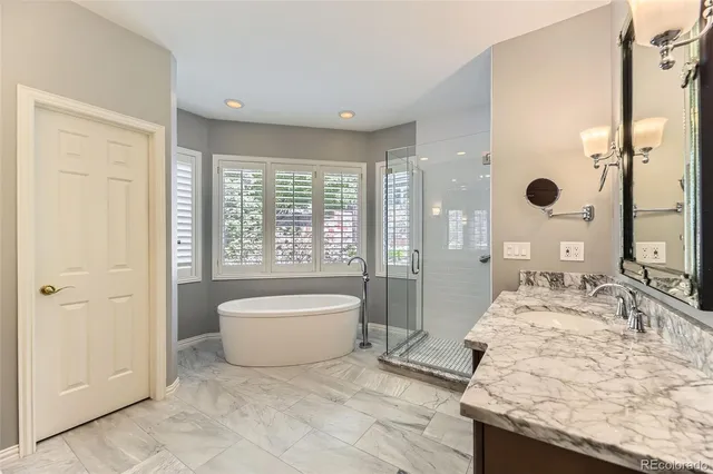 a bathroom with a granite countertop sink double and mirror
