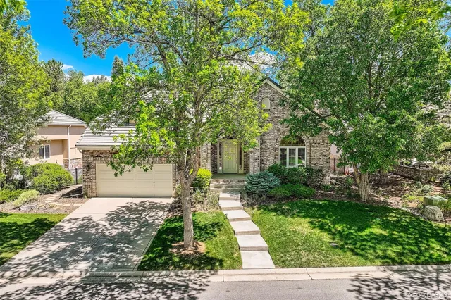 an aerial view of residential house with outdoor space and trees all around