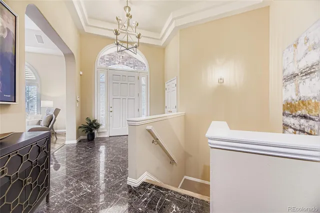 a living room with furniture and a chandelier