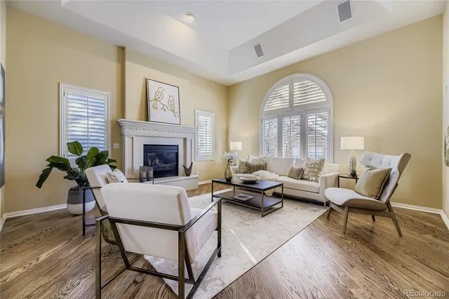 a living room with furniture fireplace and a large window