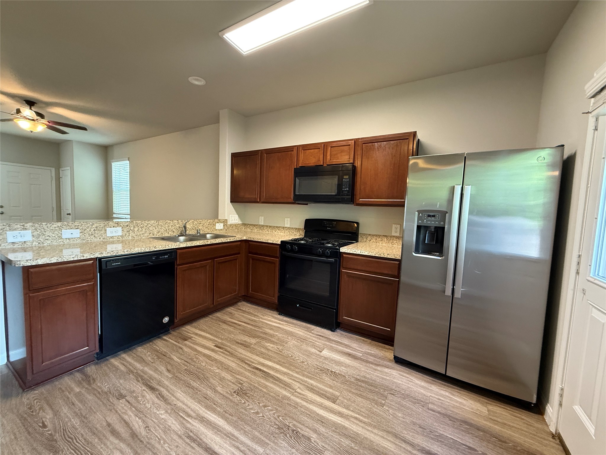 5842 Adelaide River Drive Katy, TX 77449 - Photo 12 of 40 a kitchen with stainless steel appliances granite countertop a refrigerator and a stove top oven