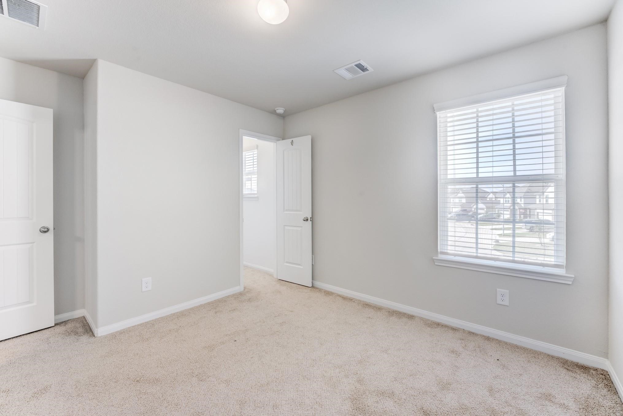 5842 Adelaide River Drive Katy, TX 77449 - Photo 32 of 40 an empty room with windows