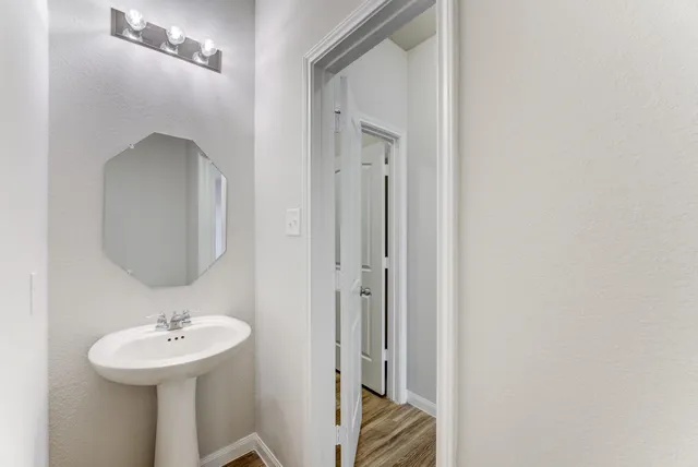 a bathroom with a sink a mirror and a toilet