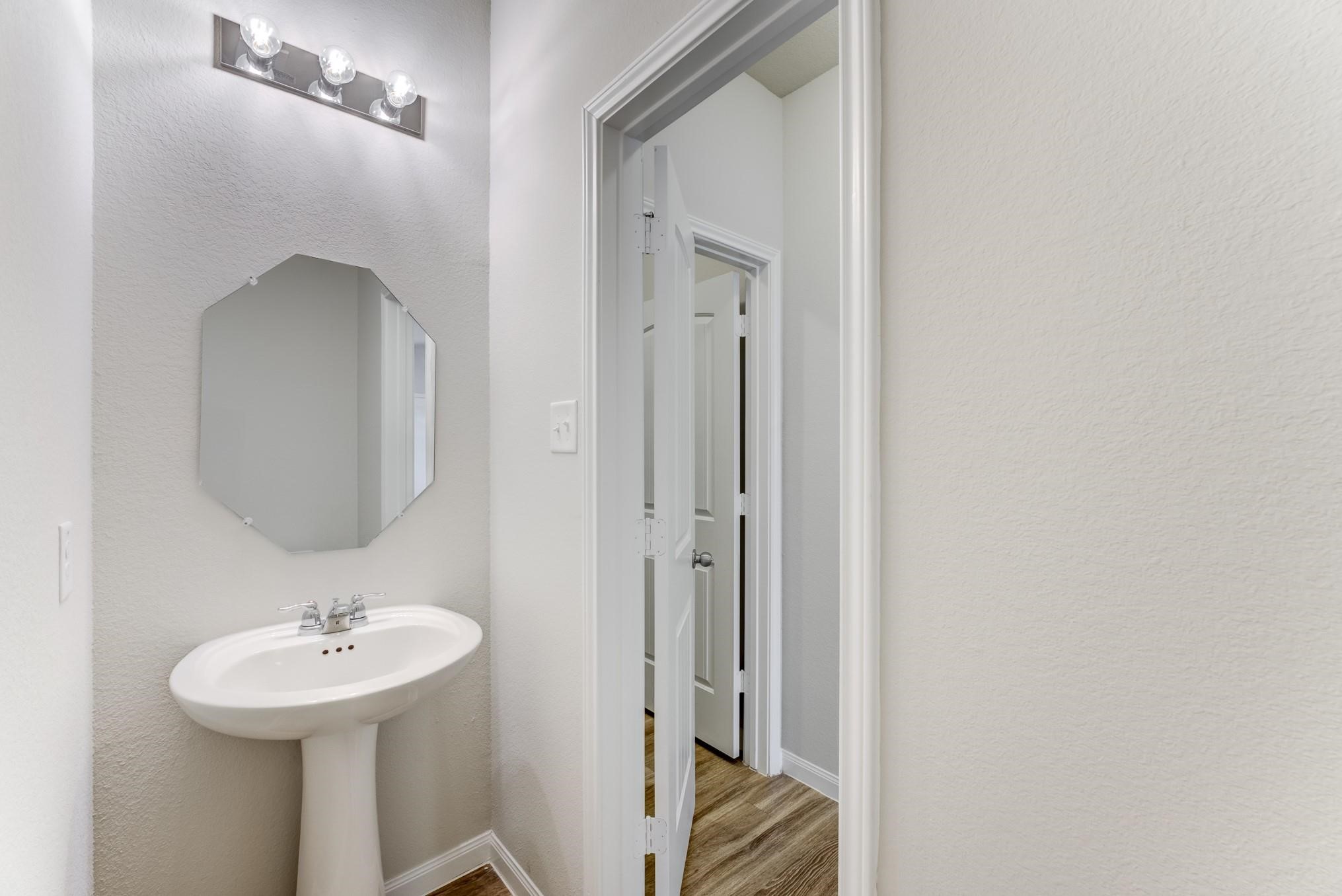 5842 Adelaide River Drive Katy, TX 77449 - Photo 34 of 40 a bathroom with a sink a mirror and a toilet