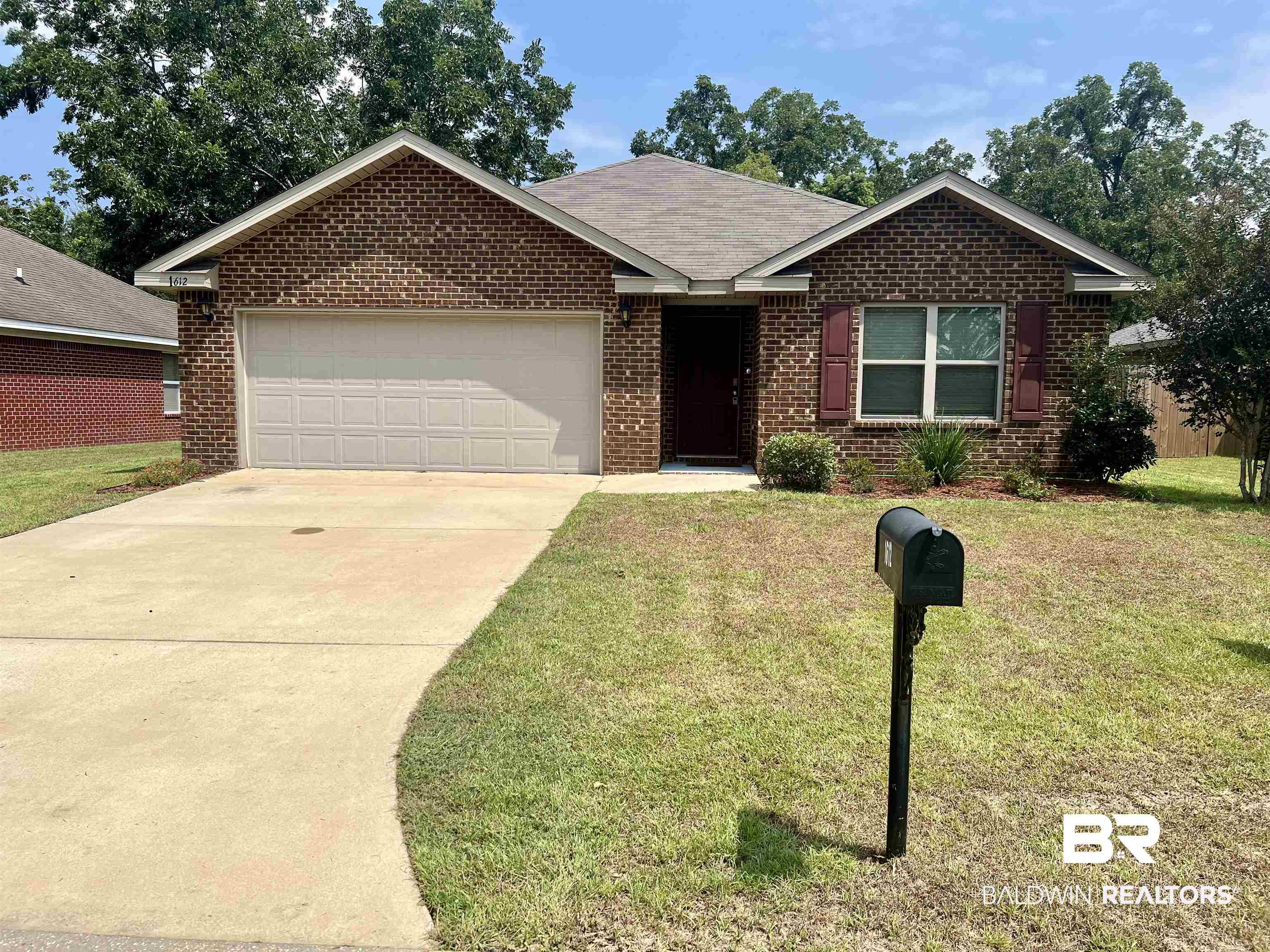 1612 Abbey Loop Foley, AL 36535 - Photo 28 of 30 Ranch-style home featuring a garage and a front lawn