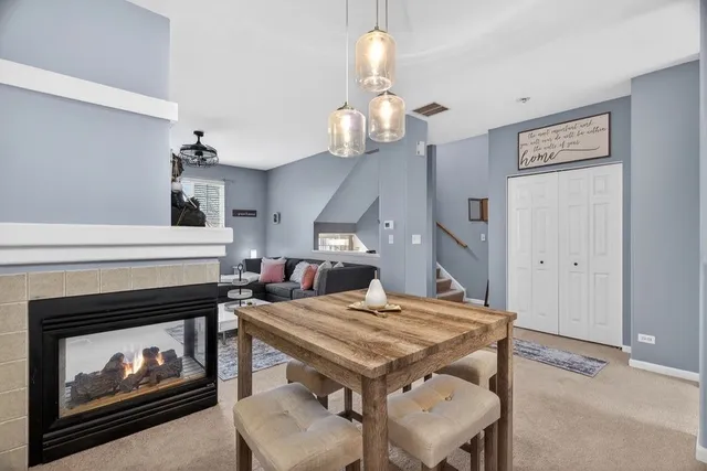 a dining room with a table chairs and a fireplace