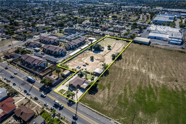 an aerial view of a residential houses with outdoor space