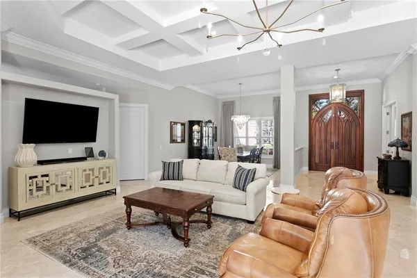 a dining room with furniture and chandelier
