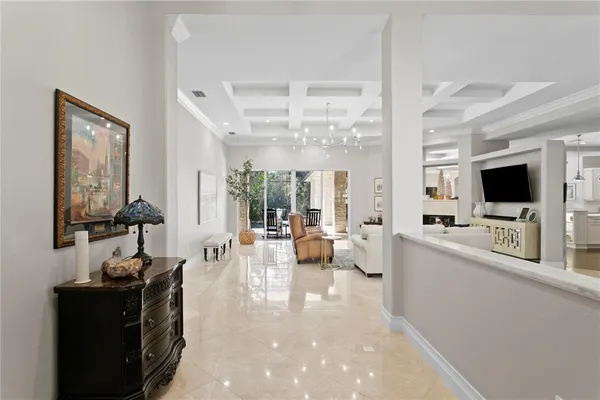a living room with furniture a flat screen tv and a large window