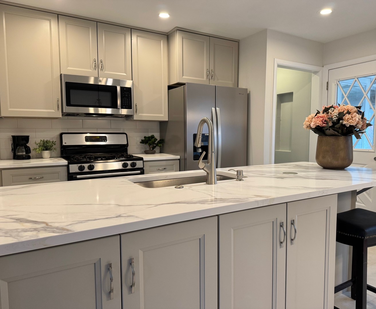 1411 Anthony Road Wheeling, IL 60090 - Photo 2 of 37 a kitchen with stainless steel appliances kitchen island granite countertop a refrigerator and a stove top oven