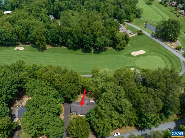 a view of a golf club with a flower garden