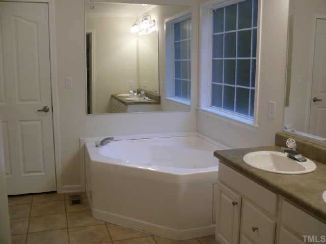 11409 Six Forks Road Raleigh, NC 27614 - Photo 3 of 4 a bathroom with a sink and a mirror
