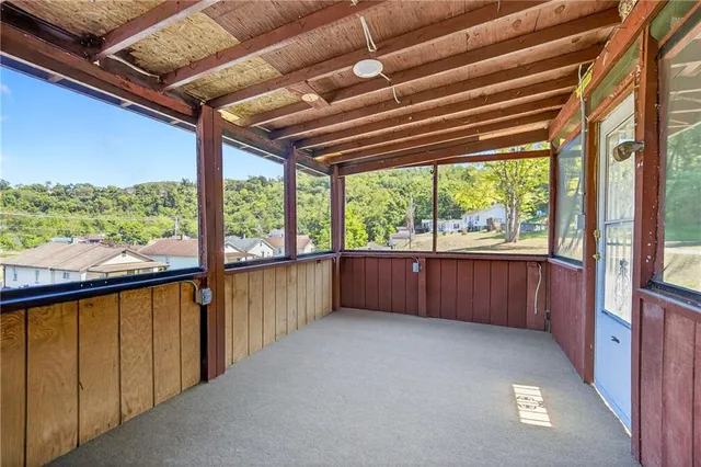a view of an empty room with brick wall