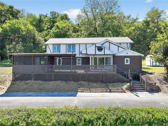 a front view of a house with a garden