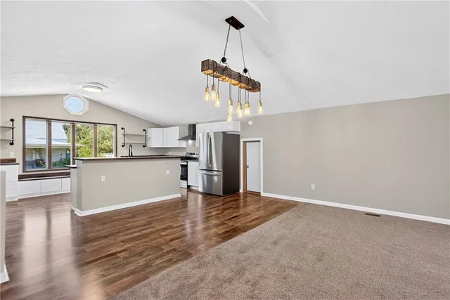 a kitchen with granite countertop a sink and cabinets