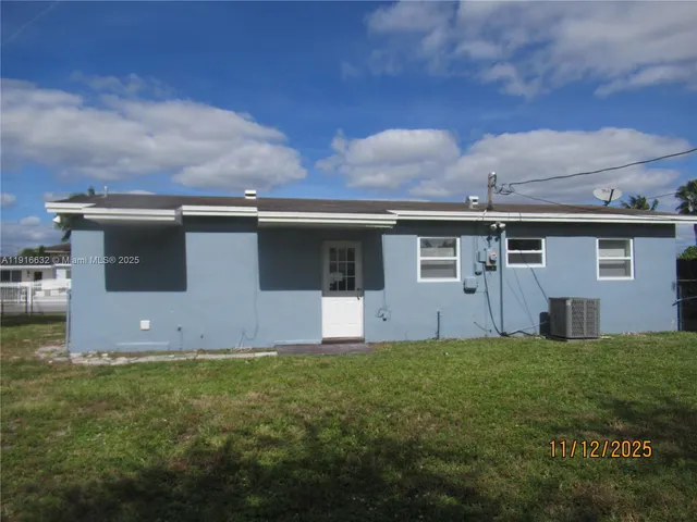 a view of a backyard with plants and a garden