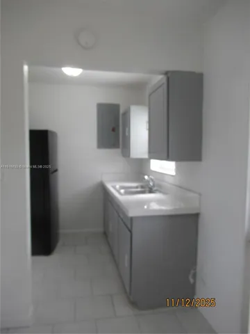 a kitchen with a sink and refrigerator