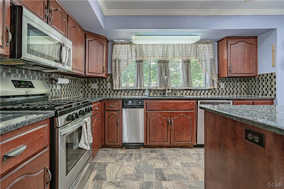 694 Bok Road Nazareth, PA 18064 - Photo 11 of 44 a kitchen with stainless steel appliances granite countertop a stove a sink and a microwave