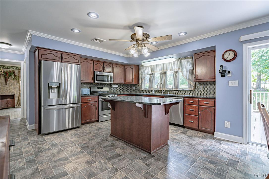 694 Bok Road Nazareth, PA 18064 - Photo 12 of 44 a kitchen with stainless steel appliances granite countertop a stove refrigerator and microwave