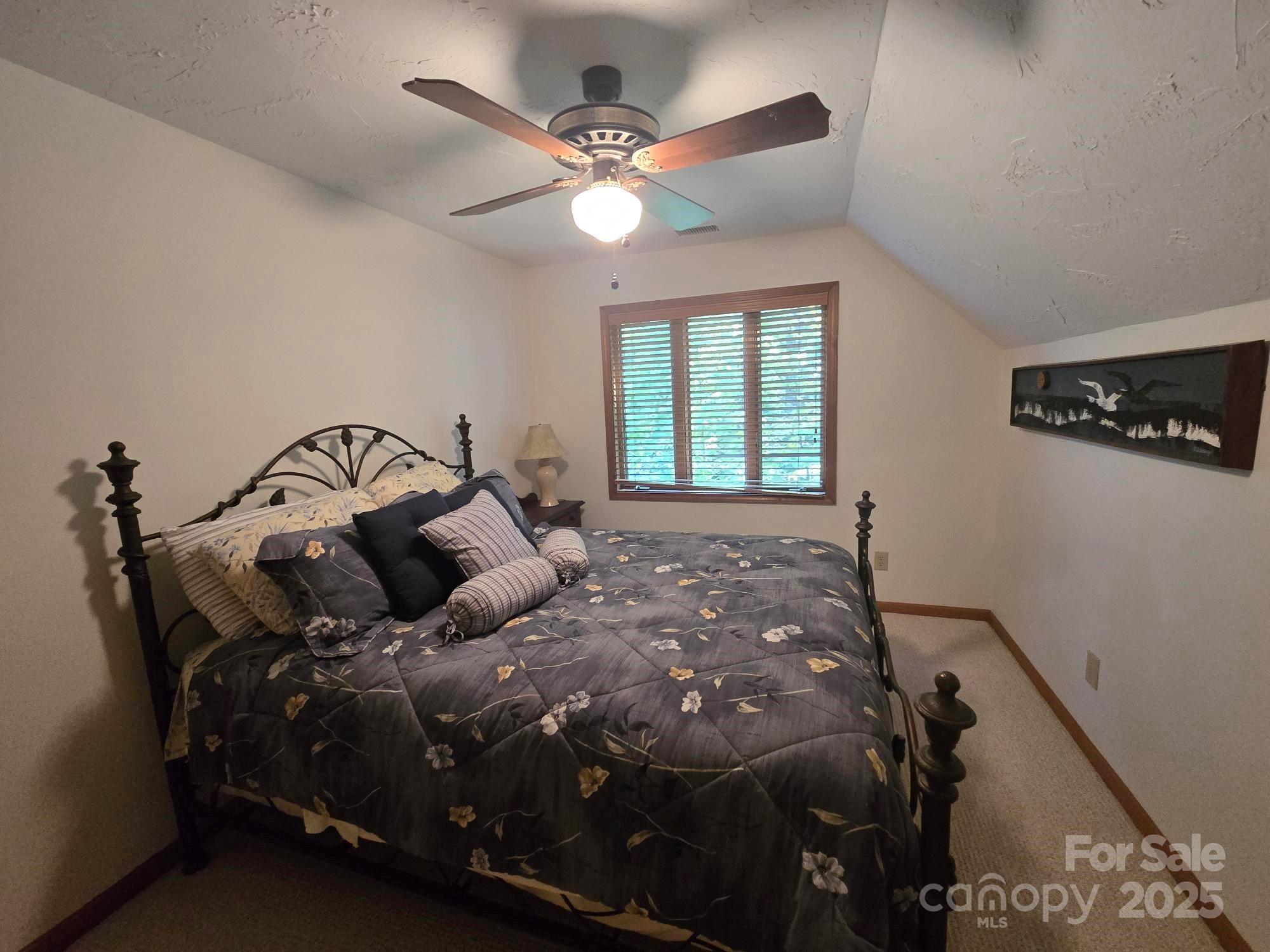 352 Bolt Road Lake Lure, NC 28746 - Photo 12 of 31 a bed sitting in a bedroom next to a window