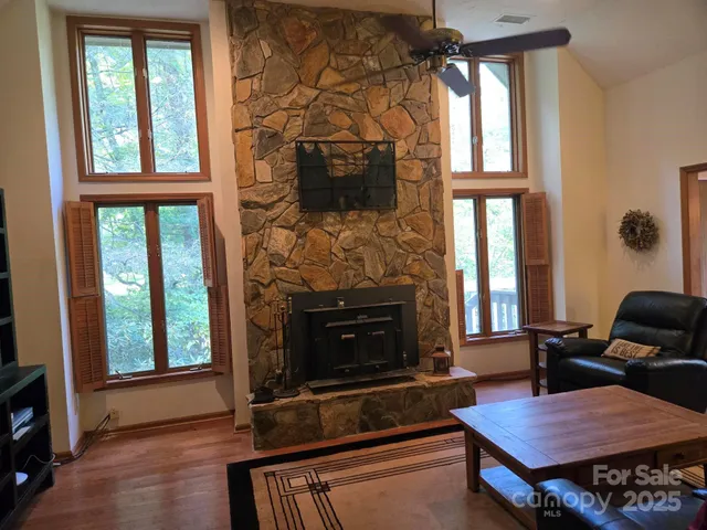 a living room with furniture fireplace and flat screen tv