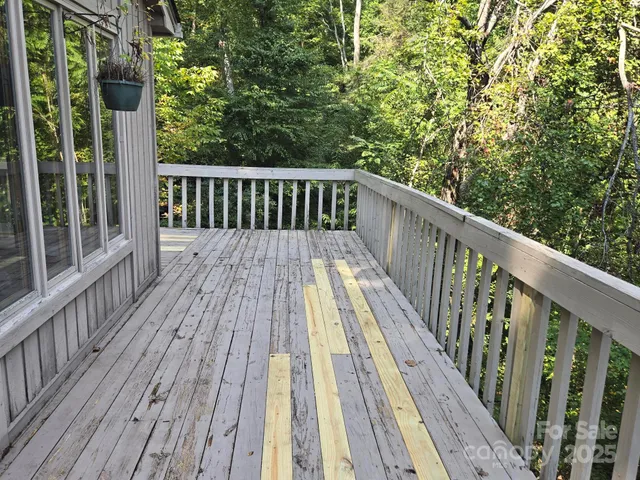 a view of balcony with wooden floor and fence