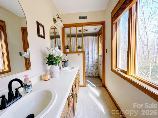 a view of a house with a yard and pathway