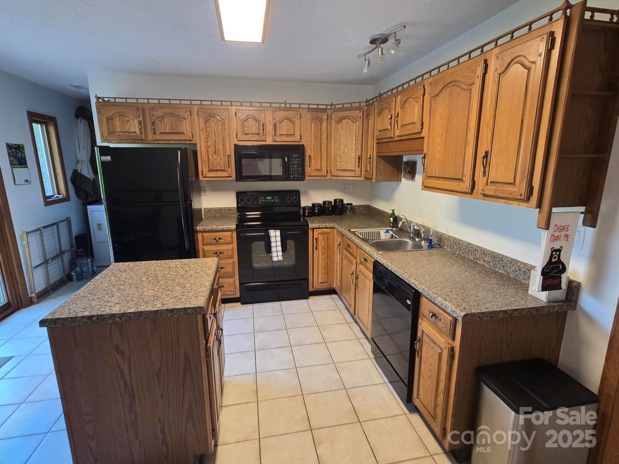 352 Bolt Road Lake Lure, NC 28746 - Photo 7 of 31 a kitchen with stainless steel appliances granite countertop a refrigerator a stove a sink dishwasher and wooden cabinets