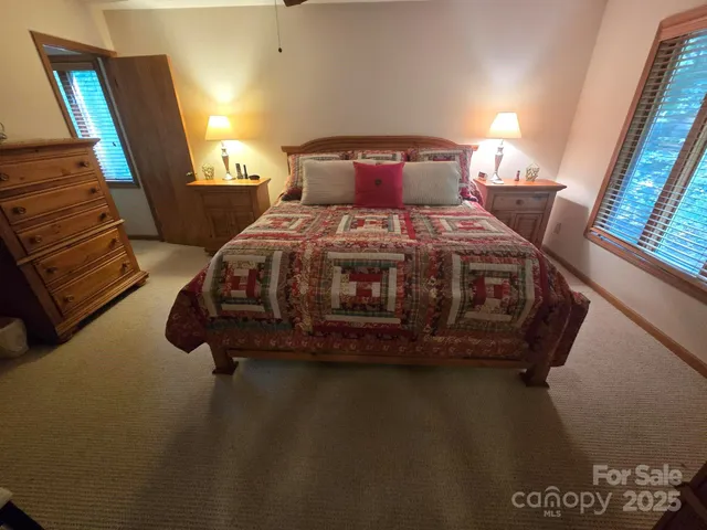 a bed sitting in a bedroom next to a window