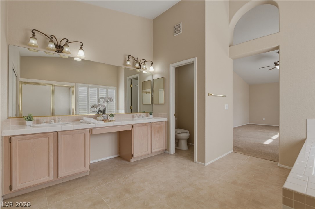 29 Olive Tree Henderson, NV 89074 - Photo 32 of 60 This primary bathroom offers dual vanities and a private water closet.
