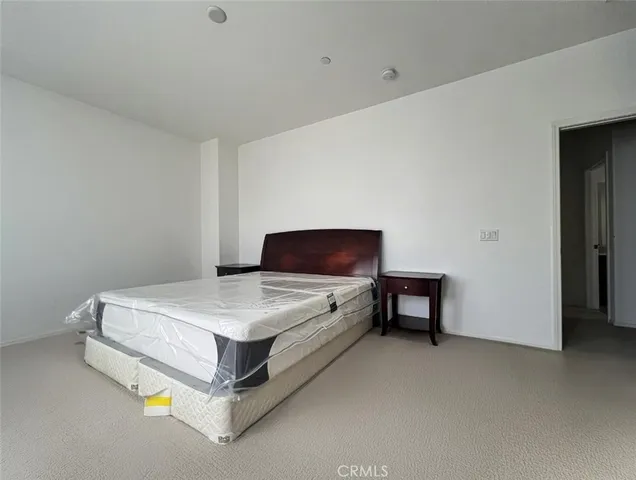 a bedroom with a bed and a table