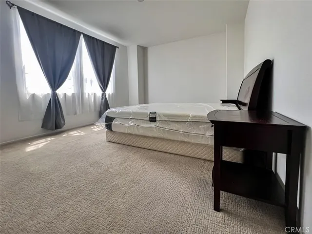 a bedroom with a bed and a desk