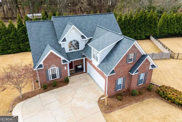 an aerial view of a house with a yard