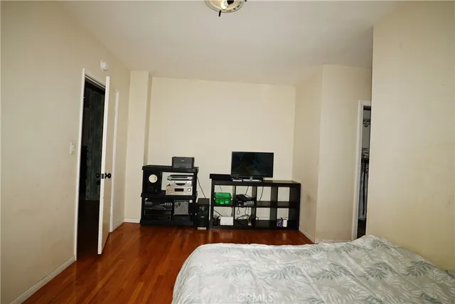 a bedroom with furniture and a flat screen tv