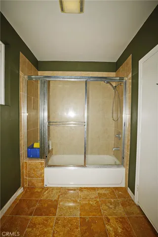 a bathroom with a bathtub and shower