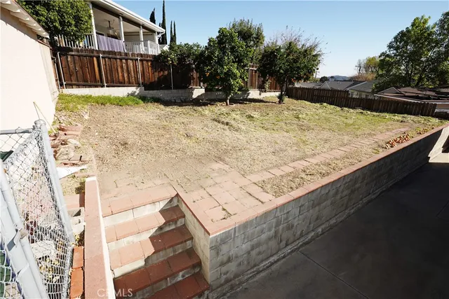 a view of a backyard of the house
