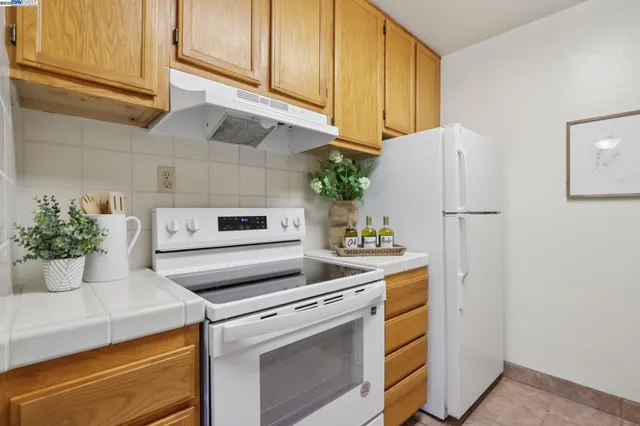a kitchen with a stove and a refrigerator